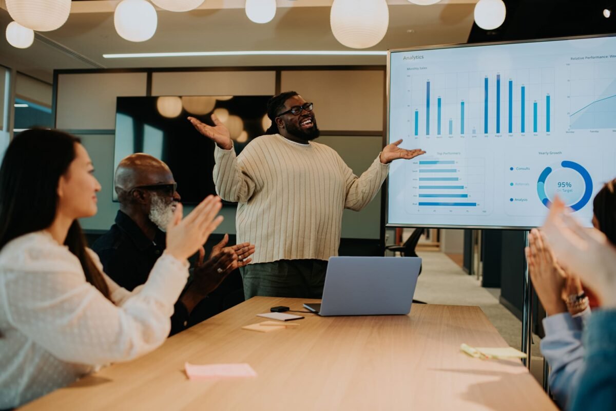A young happy male pitching an idea in front of a teamhow to pitch ideas
